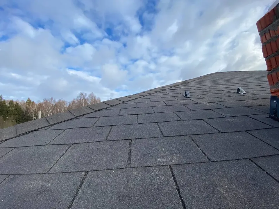 Кровля из гибкой черепицы у кирпичной трубы